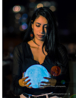 woman holding a glowing blue orb at night portrait photography