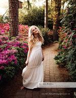 woman in white dress on a garden path lined with azaleas senior portrait photography