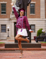 graduate posing beside a campus statue senior portrait photography