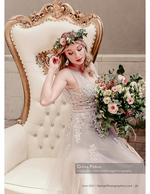bride seated in an ornate gold chair with a bouquet bridal photography