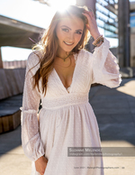 woman in white lace dress backlit on a rooftop portrait photography