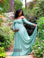 pregnant woman in a teal gown in a garden maternity photography