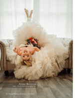 bride laughing upside-down on a couch with her bouquet bridal photography