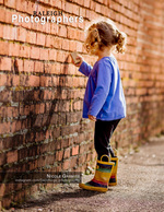 little girl drawing on a brick wall back cover family photography