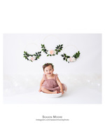 smiling baby in a floral hoop backdrop portrait photography