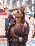 woman in striped blazer under string lights fashion photography