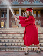 graduate in cap and gown popping champagne portrait photography