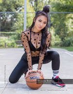 woman kneeling on a basketball court with a ball fashion photography