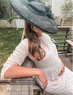 pregnant woman in a wide-brim hat maternity photography