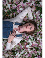 woman resting among scattered magnolia petals portrait photography