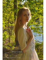 woman in a cream dress by a wooded lake portrait photography