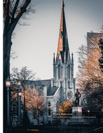 church steeple and statue at dusk cityscape photography