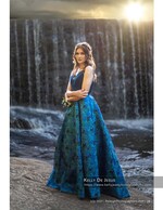 woman in a blue ballgown in front of a waterfall portrait photography