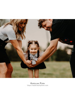 parents swinging a toddler by the arms family photography