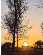 sunset framed through a circular arch sculpture landscape photography