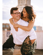 couple laughing on a rooftop piggyback ride portrait photography