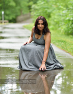 woman kneeling in a rain puddle reflection portrait photography