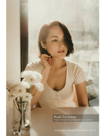woman in window light with flowers portrait photography
