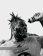 athlete in Wolfpack training gear with a water splash sports photography