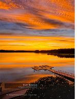 fiery sunset over a lake with a dock nature photography