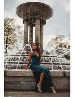 woman in teal gown beside a large fountain portrait photography
