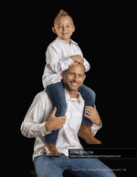 father carrying his son on his shoulders studio family photography