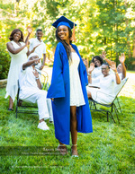 graduate cheered on by family in a backyard senior photography