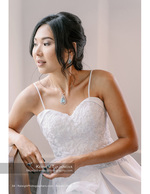 bride in lace gown with a teardrop pendant necklace bridal photography
