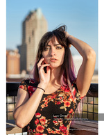 woman in a floral top on a rooftop overlooking downtown fashion photography