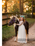 little girl embracing a unicorn-costumed pony family photography