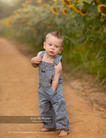 toddler boy in striped overalls on a dirt path family photography