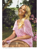 woman smiling in a garden among pink flowers portrait photography