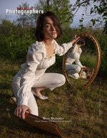woman kneeling beside an ornate mirror in a field back cover portrait photography