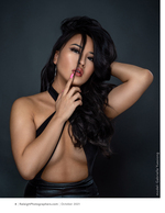 woman in a black halter top against a dark backdrop portrait photography