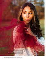 woman with a flowing red tulle scarf in a golden field portrait photography