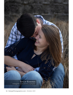 engaged couple embracing in a grassy field portrait photography