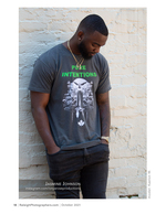 man leaning against a brick wall in a graphic t-shirt portrait photography