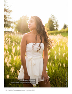 woman in a white dress standing in golden backlit grass portrait photography