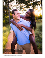 man giving his fiancee a piggyback ride in the park portrait photography