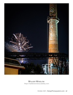 fireworks bursting beside the Lucky Strike smokestack cityscape photography