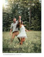 couple dancing together in a grassy meadow portrait photography
