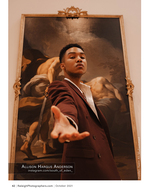 man in a maroon suit posing before a classical painting portrait photography