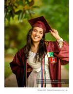 graduate wearing cap and gown with international flag patches portrait photography