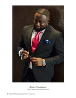 man in black suit adjusting his jacket button portrait photography