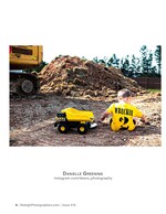 toddler with a toy dump truck at a construction site family photography