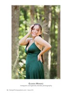 woman in emerald gown with a gold sunburst headpiece in the woods portrait photography