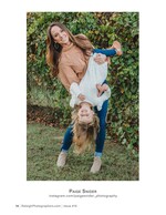 mother holding her laughing daughter upside down family photography
