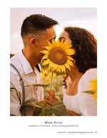couple kissing behind a single sunflower engagement photography
