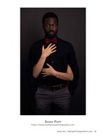 man in a red bow tie with hands resting over his heart portrait photography