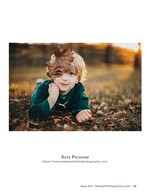 boy peeking through a fallen autumn leaf family photography